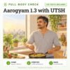 Aarogyam 1.3 with UTSH: 100 tests included, full-body health check package with home sample collection. Illustration: a man cooking poha for breakfast at home.